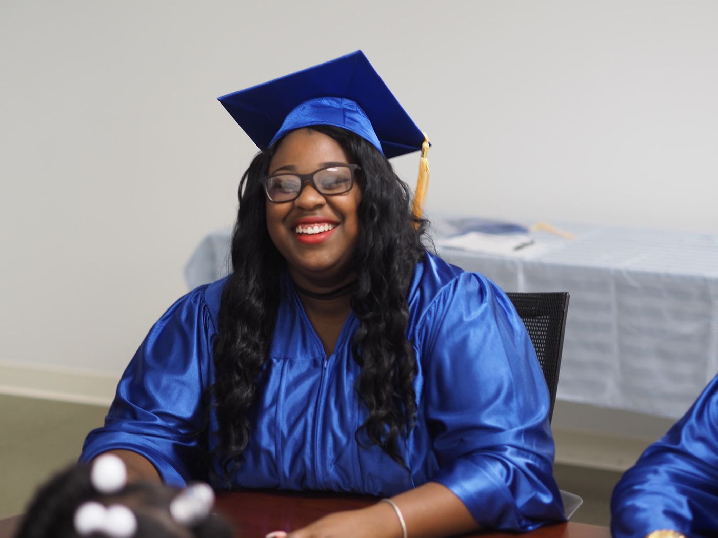 A LifePoint Career Institute graduate in cap and gown.